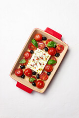 Baked feta cheese with tomatoes and olives. Healthy food. Vegetarian food.