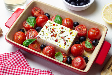 Baked feta cheese with tomatoes and olives. Healthy food. Vegetarian food.