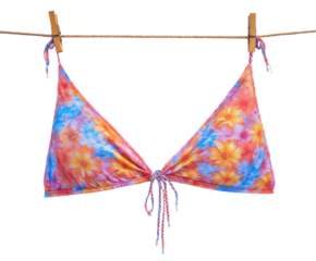 Colorful floral bikini hanging on clothesline for summer vibes