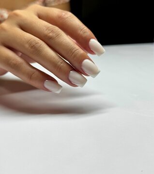 Elegant hand with square white acrylic nails