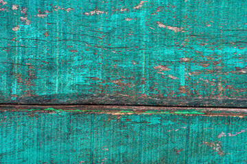 Obraz premium Green wooden textured plaster surface withsubtle shadow play, distressed old wood grunge background, scratched green paint, rustic weathered wood background, peeling blue paint