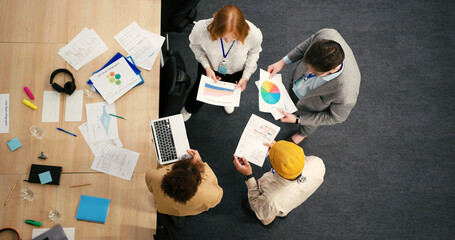 Diverse professionals engage in dynamic discussion in office