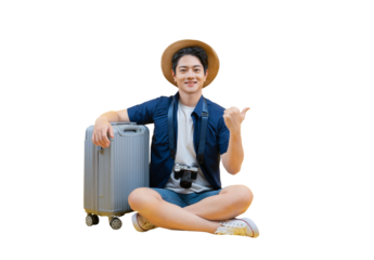 Happy traveler resting with a suitcase and hat, ready for adventure. A young man poses in a travel outfit with a suitcase. He is holding his thumb up. on png background