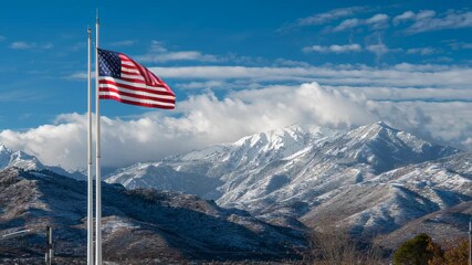 American flag waving over snowy mountains - Powered by Adobe