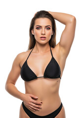 Fototapeta premium A stunning brunette model in a classic black bikini poses with confidence, her topaz-like beauty captured in a high-quality studio shot, Isolated on a Transparent Background PNG.