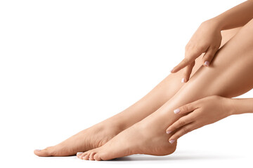 Feet of young woman with fresh pedicure isolated on white background, closeup