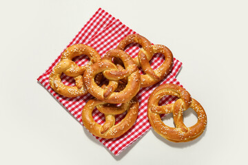 Tasty salted pretzels on grey background