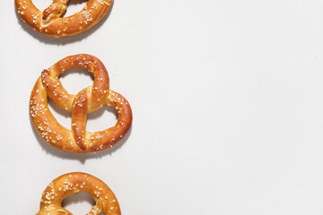 Tasty salted pretzels on grey background