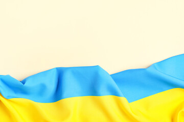 Flag of Ukraine on pale orange background, top view