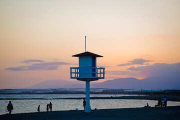 Almerimar beach and lifeguard tower silhouette at sunset in summer time. Almeria, Spain