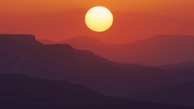 Sunrise over mountain range. Time lapse nature scene.