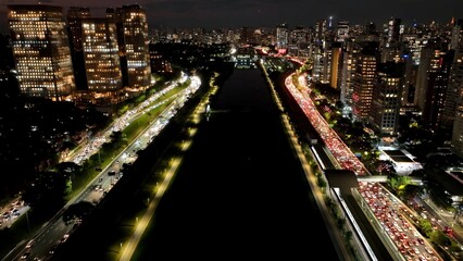 Fototapeta premium Freeway Traffic In City Night Sao Paulo Brazil. Highway Interchange Crossing City With Traffic Jam. Building Town Sky Background Illuminated Urban. Illuminated City Landmark. City Night Sao Paulo.