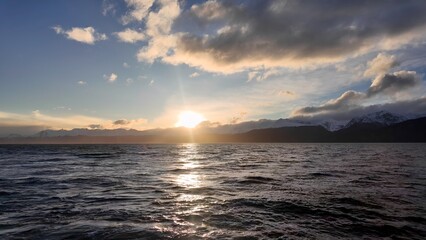 Obraz premium Sunset Bay Water In Ushuaia Tierra Del Fuego Argentina. Bird Eye View Of A Amazing Coastal Beach In The Summer Holiday. Sunset Snowy Illumination Patagonia Landscape Blizzard.