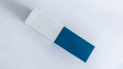 Close-up shot of the rectangular lipstick packaging, with a blue tip