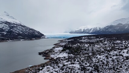 Perito Moreno Glacier In El Calafate Santa Cruz Argentina. Glacier Calving Into Icy Lagoon With Snow Capped Mountains. Outdoor Tourism Icon Patagonia Glacier. Snow Covered High Angle View.