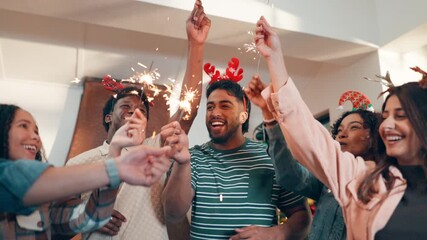 Christmas, sparklers and people in home for party, celebration or event in festive season together. Happy, fireworks and group of excited friends dancing for xmas holiday with reunion in apartment. - Powered by Adobe