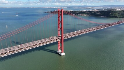 25 Of April Bridge In Lisbon Portugal. Bridge Showcasing The Traffic Flowing Across In The City....