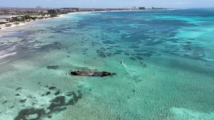 Shipwreck In Noord Oranjestad Aruba. Tourists Enjoying Boat Trip Over Tropical Water Scenery. Shore...