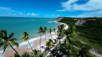 Fototapeta premium Tambaba Beach In Conde Paraiba Brazil. Turquoise Ocean Waves Gently Crashing On Tropical Beach. Shore Clouds Sky Beach Sea. Seaside Panorama. Conde Paraiba.