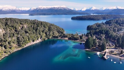 Naklejka premium Patagonia Skyline In Villa La Angostura Neuquen Argentina. Bird Eye View Of A Amazing Coastal Beach In The Summer Holiday. Nature Travel Destinations Snow Covered Forest Trees.