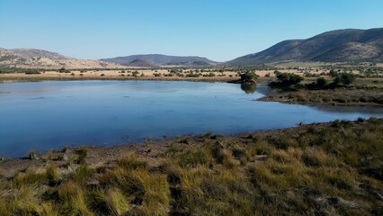 Obraz premium African Lake In Rustenburg North West South Africa. Wildness Safari Scene Of Game Drive With Big Five Animals. Nature Clouds Sky Sky Forest. Nature Panoramic. Rustenburg North West.