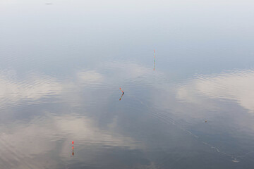 floats on the surface of the reservoir and the reflection of the sky on the surface of the water