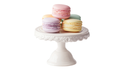 Delicate macarons on a small white pedestal stand.  Pastel colored macarons in a stack rest atop a decorative, scalloped, white cake stand