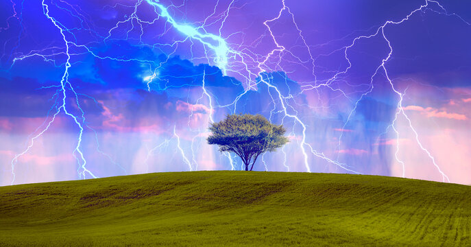Thunder and lightning over the rural landscape with lone tree