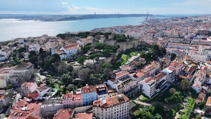 Fototapeta premium Sao Jorge Castle In Lisbon Portugal. Modern City Center With Skyscrapers Reflecting The Urban Life. Town Sky Clouds Backgrounds Urban. Town Outdoor Downtown Panning Wide. Lisbon Portugal.