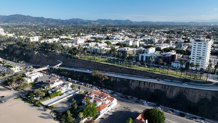 Obraz premium Santa Monica In Los Angeles California United States. Breathtaking Aerial View Of A Lush Tropical Coastline Scenery. Business Sky Clouds Downtown Cityscape. Outdoor Downtown Panning Wide.