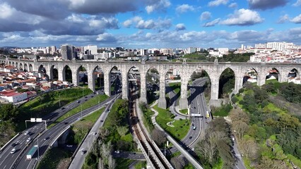 Obraz premium Aguas Livres Aqueduct In Lisbon Portugal. Aerial View Of Landmark Medieval Building In Downtown Scene. Industrial Landscape Buildings Stunning. Urban Buildings Town. Lisbon Portugal.