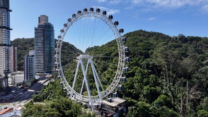 Obraz premium Famous Ferris Wheel In Balneario Camboriu Santa Catarina Brazil. Ferris Wheel Shining Over Downtown District Landscape. Industrial Skyline Skyscrapers Amazing. Industrial Cityscape.
