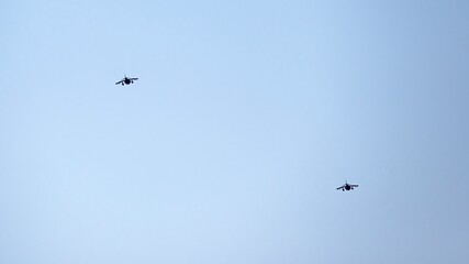 Two Spanish Navy Harrier fighter jets flying in formation against a clear blue sky during a...
