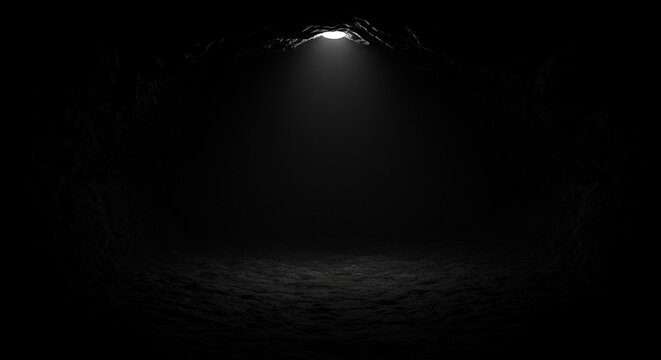 Dark room with a single spotlight shining down from the ceiling onto a textured floor with a small beam of light in a dark space.