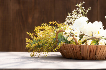 Mimosa and White Blossoms in Woven Basket on Table
