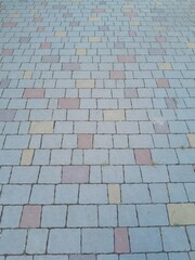 Texture of street tiles. Pattern of gray sidewalk tiles close up