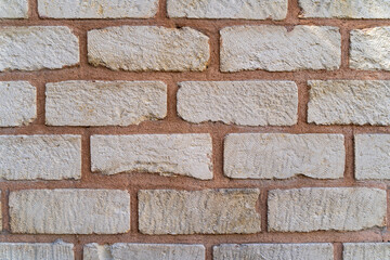 Textured white brick wall with visible mortar joints, showcasing a rustic and natural appearance, ideal for backgrounds, interior design, and architectural projects emphasizing durability and style