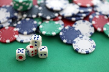 Dice game on the poker table in the casino. A successful combination of dice brought a lot of winning chips