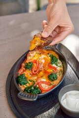 Delicious Cheesy Spinach and Tomato Bake Served with Crispy Bread and Creamy Sauce for a Perfect Comfort Meal