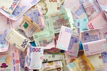 Big amount of different Ukrainian hryvnia money bills. Pile of crumpled ukrainian banknotes