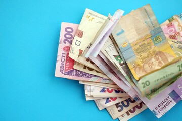 Ukrainian money bills on light blue paper background
