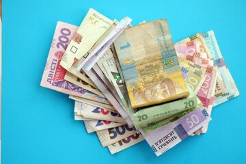 Ukrainian money bills on light blue paper background
