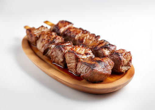 Delicious beef skewers, grilled, wood plate or tray. Isolated white background, Brazilian traditional "espetinhos de carne", bbq food	
