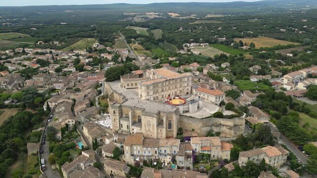 Aerial drone view of Grignan Castle surrounded by lush greenery and historic village in Provence, France &ndash; medieval fortress with scenic landscape and vibrant natural surroundings