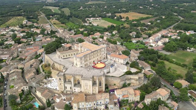 Aerial drone view of Grignan Castle surrounded by lush greenery and historic village in Provence, France &ndash; medieval fortress with scenic landscape and vibrant natural surroundings
