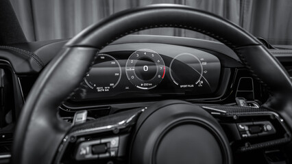 dashboard of the car is illuminated by bright illumination. Speedometer, circle tachometer, oil and...