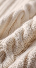 Close-up of a textured cream-colored knitted fabric
