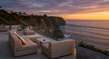 Luxury ocean view patio with modern furniture and sunset sky with oceanfront property in california