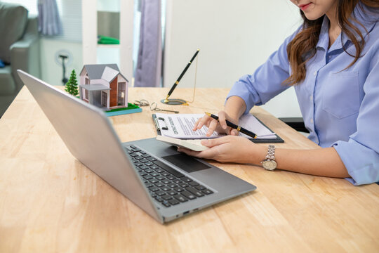 Real estate businessman or broker is calculating interest rate based on the period of time that the client wants to use in deciding to make a contract to buy a real estate. Real estate trading concept