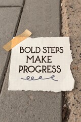 Inspirational Quote on Paper Displayed on Paved Sidewalk Surface